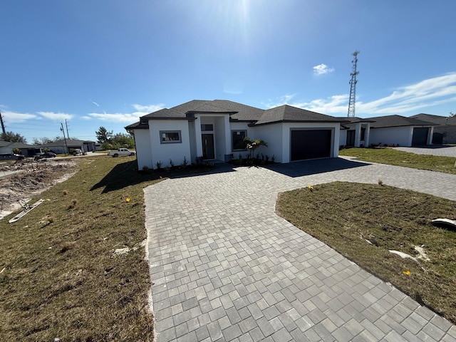 view of front of property with a garage and a front lawn