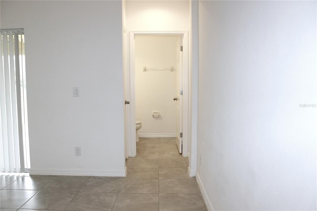 corridor with light tile patterned flooring