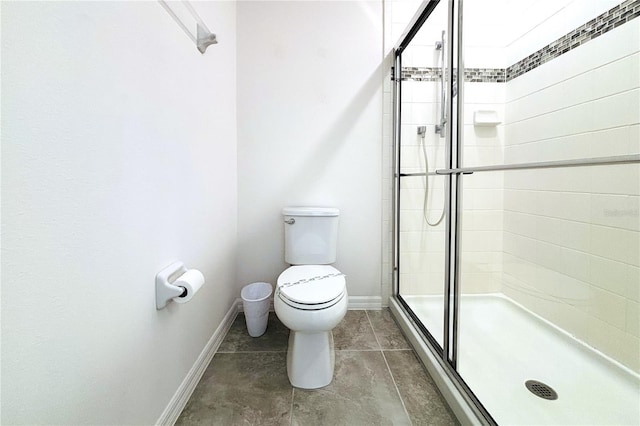 bathroom with a shower with door and toilet