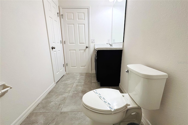 bathroom with tile patterned floors, vanity, and toilet