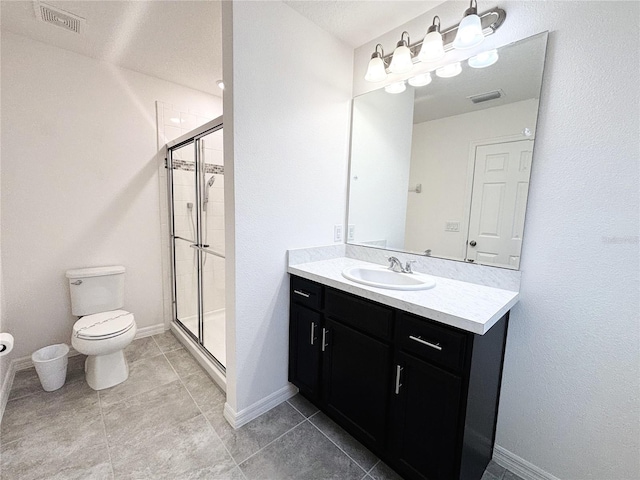 bathroom featuring tile patterned floors, vanity, toilet, and an enclosed shower