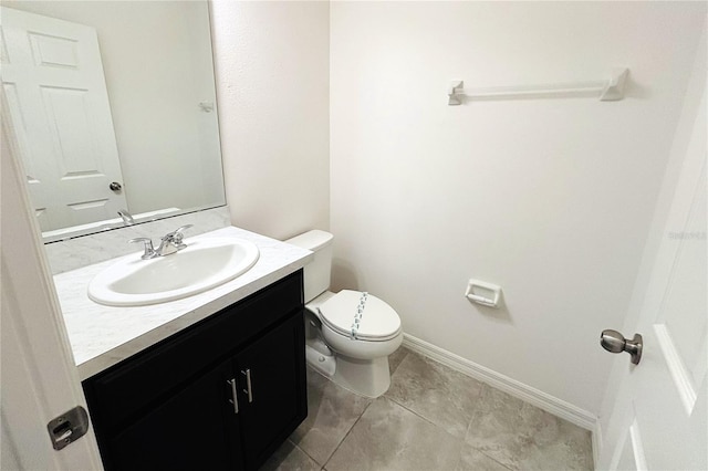 bathroom featuring vanity, tile patterned flooring, and toilet