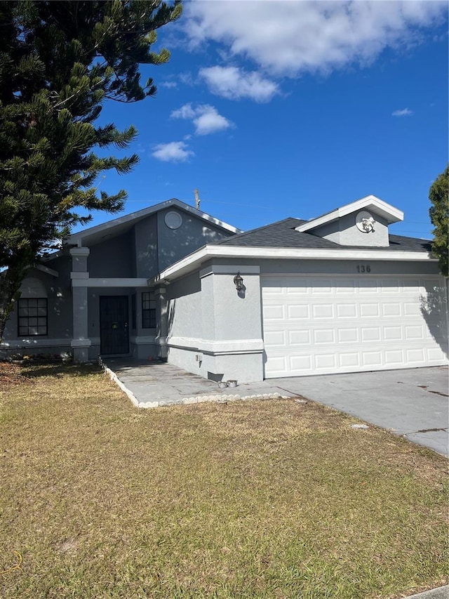 view of front of home featuring a garage and a front yard