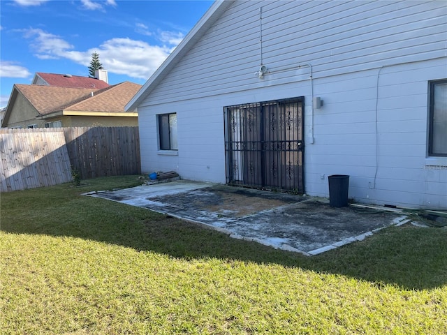 back of house with a patio and a yard