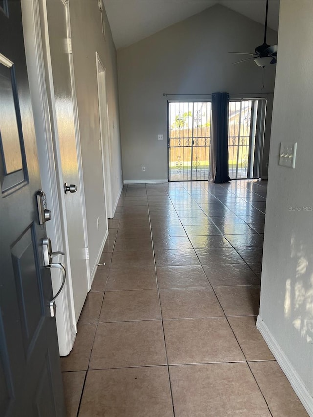 corridor featuring vaulted ceiling and tile patterned floors