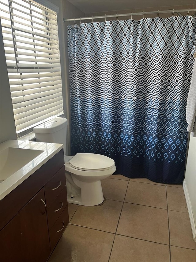 bathroom featuring vanity, tile patterned floors, and toilet