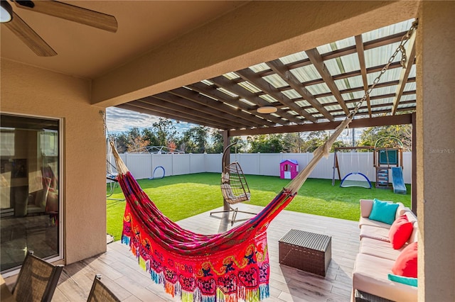 view of patio / terrace with a playground, outdoor lounge area, a deck, and ceiling fan