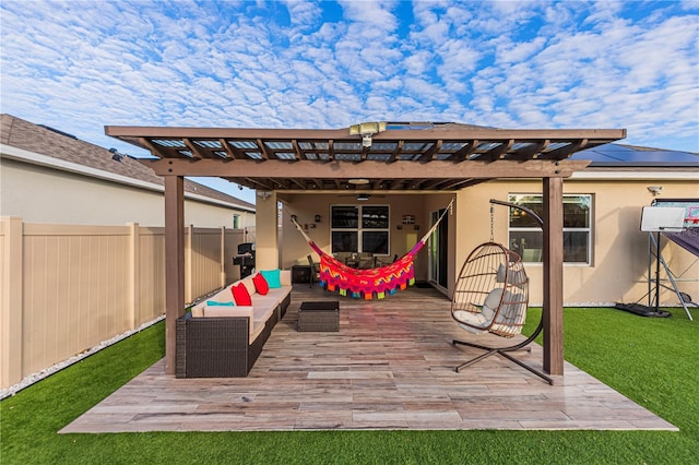 back of property featuring outdoor lounge area, a pergola, a deck, and a lawn