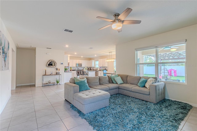 living room with light tile patterned flooring and ceiling fan