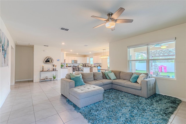 living room with ceiling fan and light tile patterned flooring