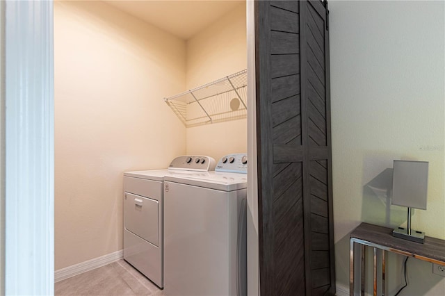 washroom with light tile patterned flooring and separate washer and dryer