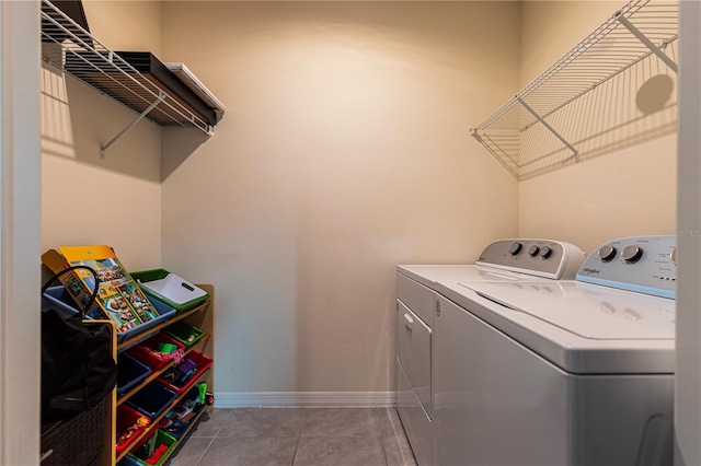 laundry room featuring washer and clothes dryer and tile patterned floors