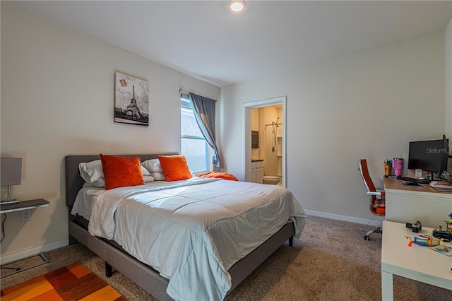 bedroom featuring ensuite bath and carpet floors