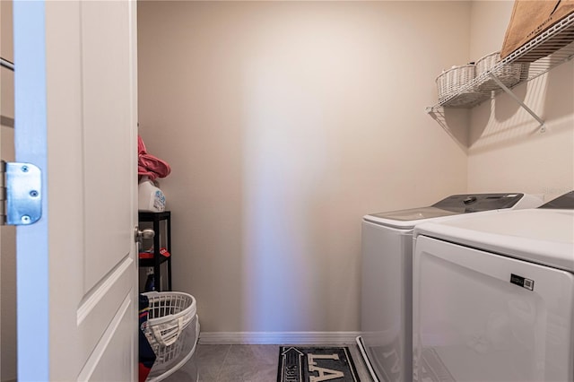 laundry room with tile patterned flooring and washer and dryer