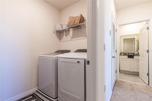 clothes washing area with washing machine and dryer and light carpet