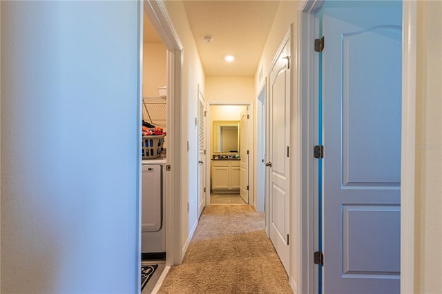 hall featuring light colored carpet and washing machine and clothes dryer