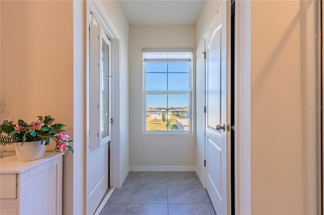 doorway to outside featuring tile patterned floors