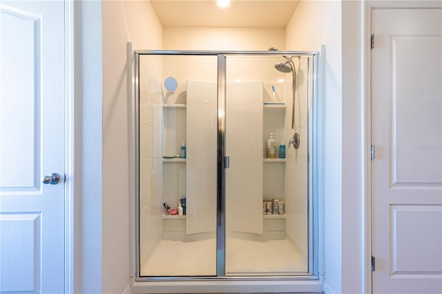 bathroom featuring a shower with shower door