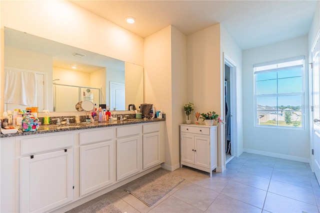 bathroom with vanity, a shower with door, and tile patterned floors