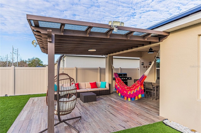 deck with ceiling fan, an outdoor living space, and a pergola