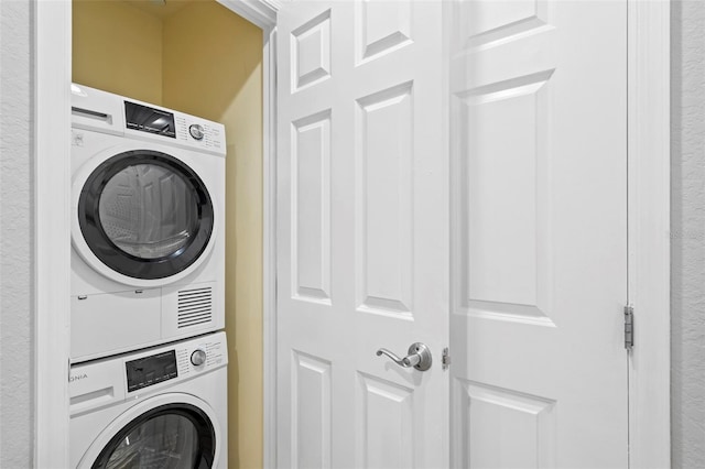 washroom with stacked washer and clothes dryer