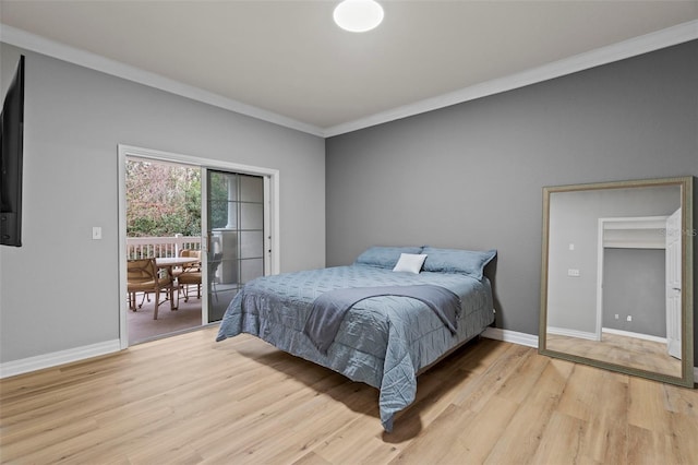 bedroom with crown molding and light hardwood / wood-style flooring