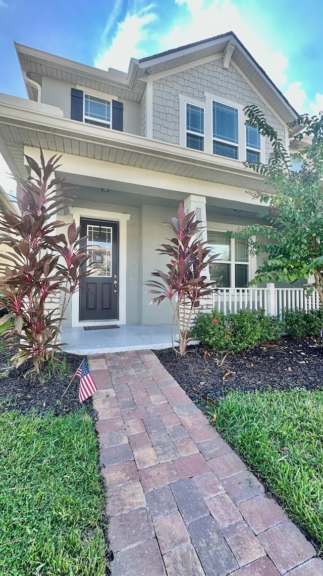 view of exterior entry featuring a porch