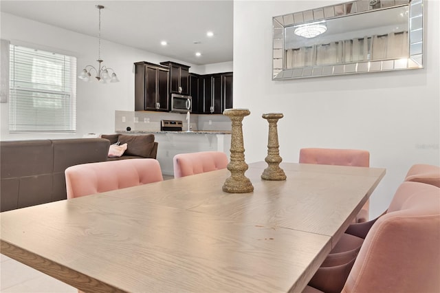 dining area featuring a chandelier and recessed lighting