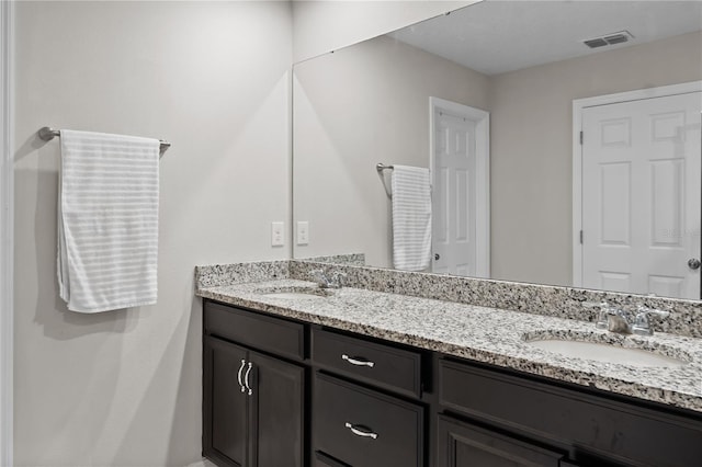 full bathroom with visible vents, a sink, and double vanity