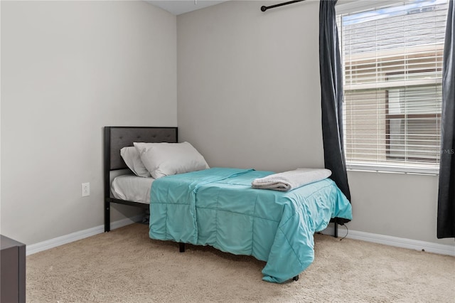 carpeted bedroom featuring baseboards