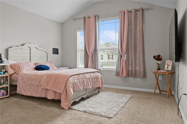 carpeted bedroom featuring vaulted ceiling and baseboards