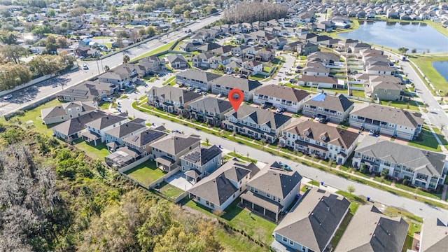 drone / aerial view with a water view and a residential view