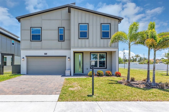 view of front of property with a garage and a front yard