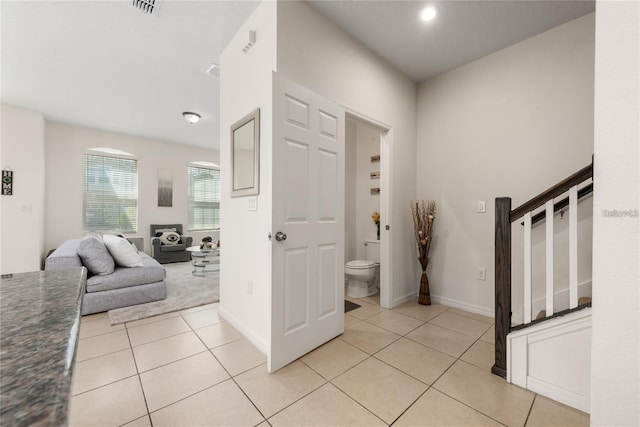 entryway with light tile patterned flooring