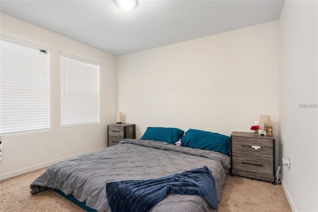 bedroom featuring light colored carpet