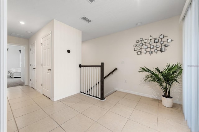 hallway with light tile patterned flooring