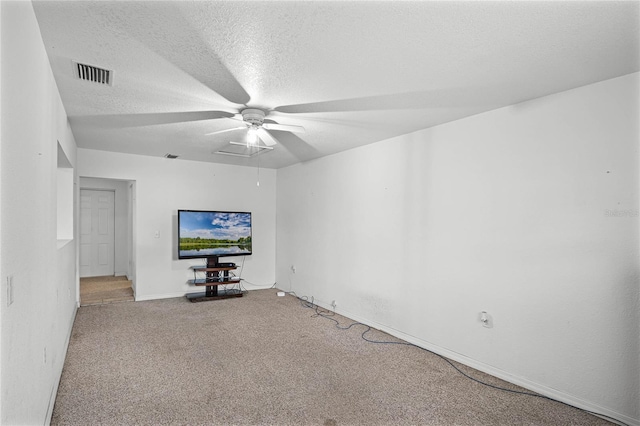 unfurnished living room featuring carpet and a textured ceiling