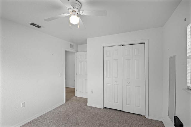 unfurnished bedroom featuring a closet, ceiling fan, and carpet flooring