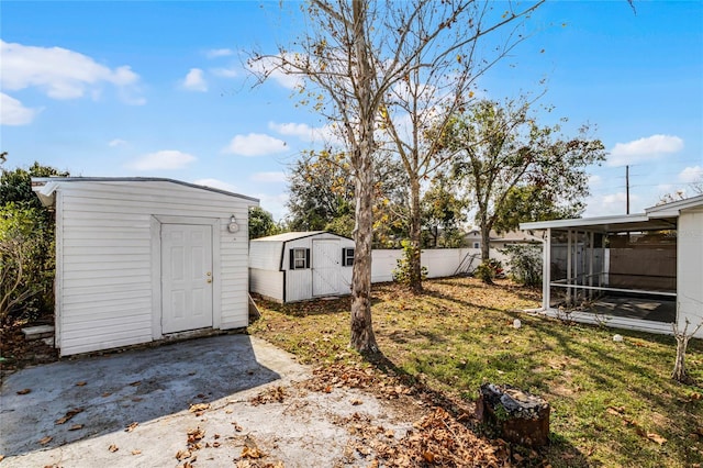 view of yard featuring a storage shed and a sunroom