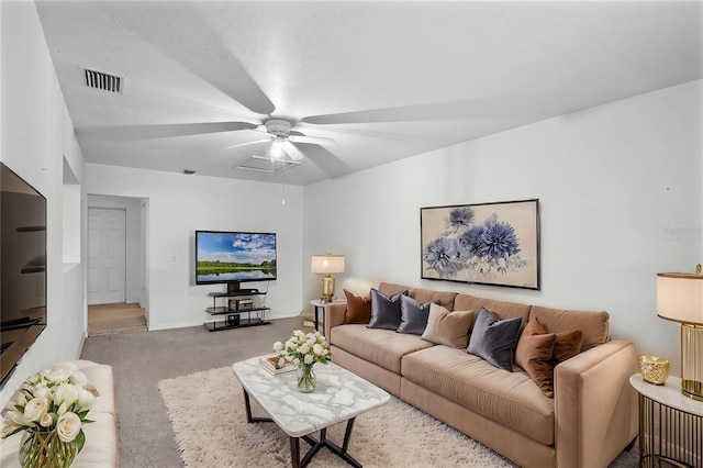 carpeted living room with ceiling fan