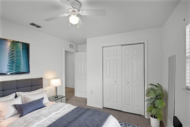 bedroom with a closet, ceiling fan, and dark colored carpet