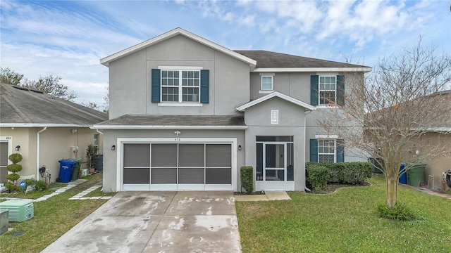 view of front property featuring a garage and a front lawn