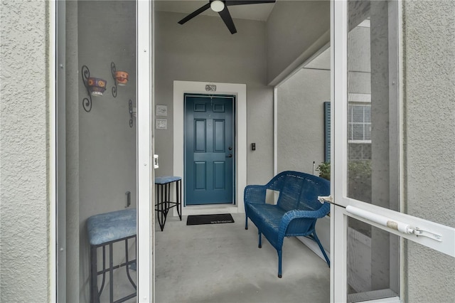 doorway to property featuring ceiling fan