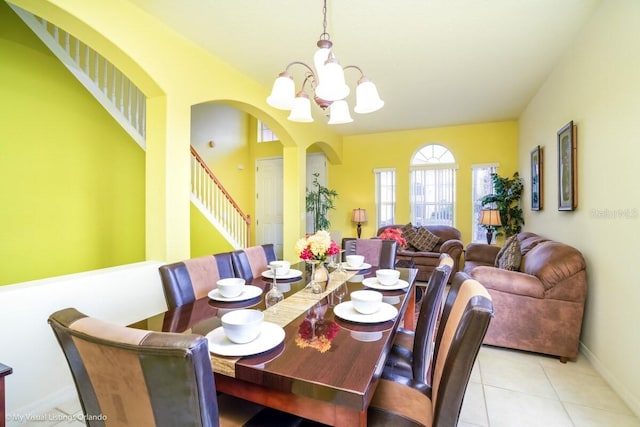 dining space featuring light tile patterned floors and a notable chandelier