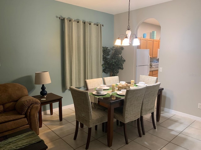 tiled dining space with an inviting chandelier