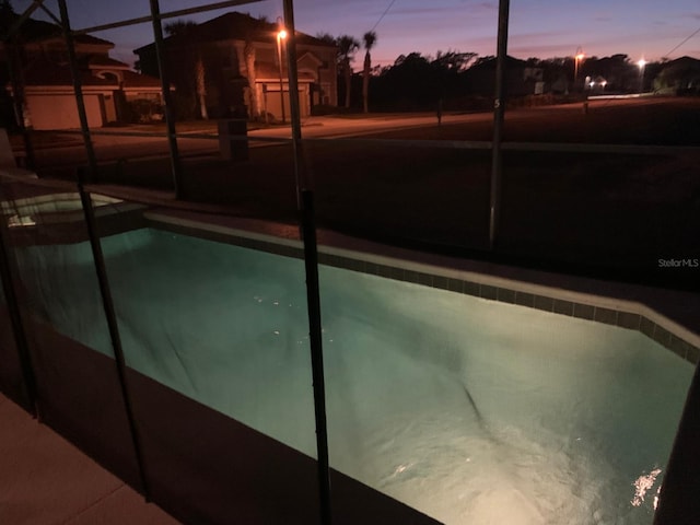 view of pool at dusk