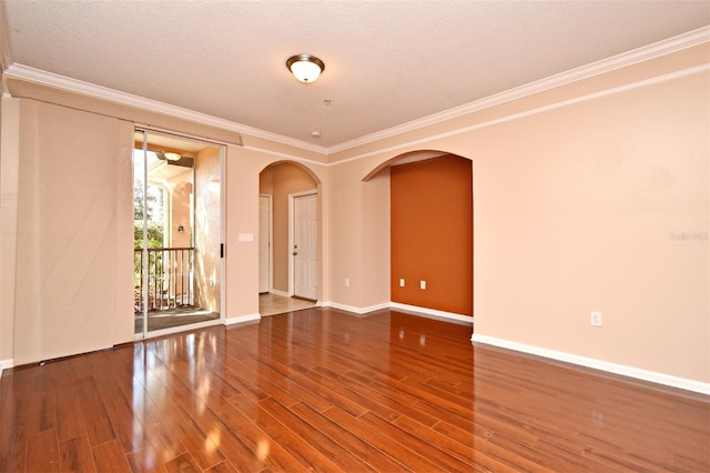 unfurnished room with hardwood / wood-style flooring, ornamental molding, and a textured ceiling