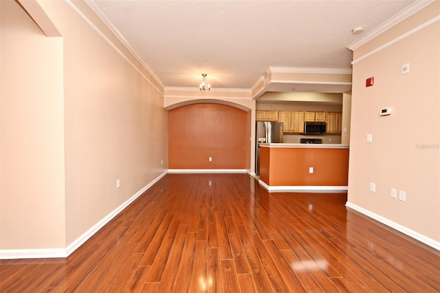 unfurnished living room with crown molding and dark wood-type flooring