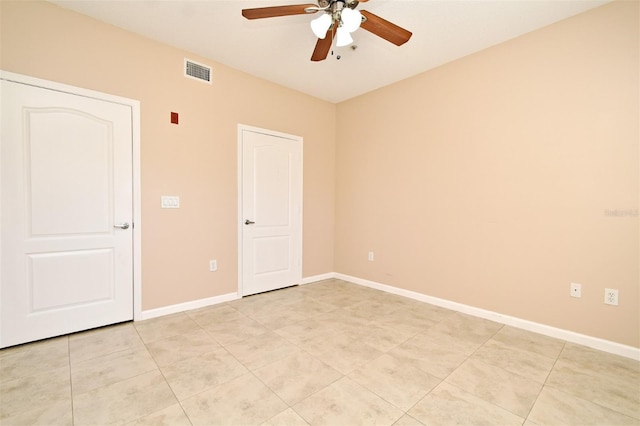 spare room with light tile patterned floors and ceiling fan