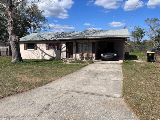 ranch-style house featuring a front yard and a carport